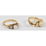 A 14ct yellow gold crossover ring set with two pearls, and a 14ct pearl and diamond three stone