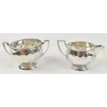 COOPER BROTHERS & SONS LTD; a George V hallmarked silver sugar bowl and matching cream jug,