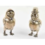 A novelty pair of circa 1900 white metal peppers each modelled as a duck, one with a hinged cover