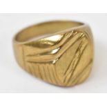 A yellow metal gents ring, stamped 18k size V, approx 12.6g.