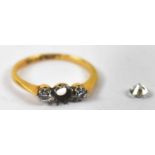 An 18ct yellow gold three stone ring, set with three diamonds (one loose from mount, af), size N,