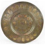 A large Indian brass circular plaque with engraved decoration, width 62cm.