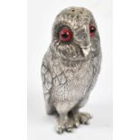 A novelty silver plated pepper in the form of an owl with screw off head and glass eyes, height 6.