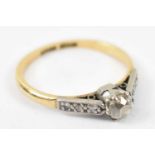 An 18ct yellow gold and platinum ring, set with central diamond and five small diamonds, size N,