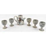 A studio pottery jug, height 16cm, and a set of five goblets (6).