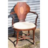An Edwardian inlaid mahogany open arm elbow chair on cabriole supports united by a stretcher.