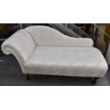 A good quality reproduction chaise longue with geometric upholstery and ball and claw feet.