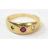 An 18ct yellow gold ring with central red stone and two smaller white stones (af), size K, approx