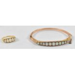 A 9ct gold bangle set with eleven opals, approx 7.2g, also a yellow metal five stone opal ring,