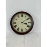 A early 20th century wall clock with painted Roman numeral dial.