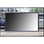 A huge modern rectangular wall mirror, the central bevelled plate surrounded by twenty-six