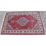 A hand knotted Persian design red ground carpet, 215 x 135cm.