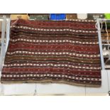 A large hand woven kilim.