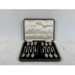 COOPER BROTHERS & SONS LTD; a George V cased set of twelve hallmarked silver teaspoons with tongs,