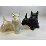 A pair of Black & White plaster advertising Scottie dogs, length approx 27cm.