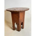 An unusual yew wood and inlaid circular occasional table raised on folding base, diameter 36cm.