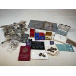 A group of coins and banknotes including single coins in individual wallets with notes, some
