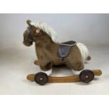 A Mamas and Papas rocking horse.