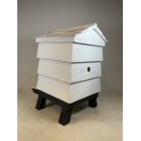 A white painted decorative wooden beehive, height 102cm.