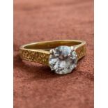 An 18ct yellow gold diamond solitaire ring with four claw set round brilliant cut stones weighing