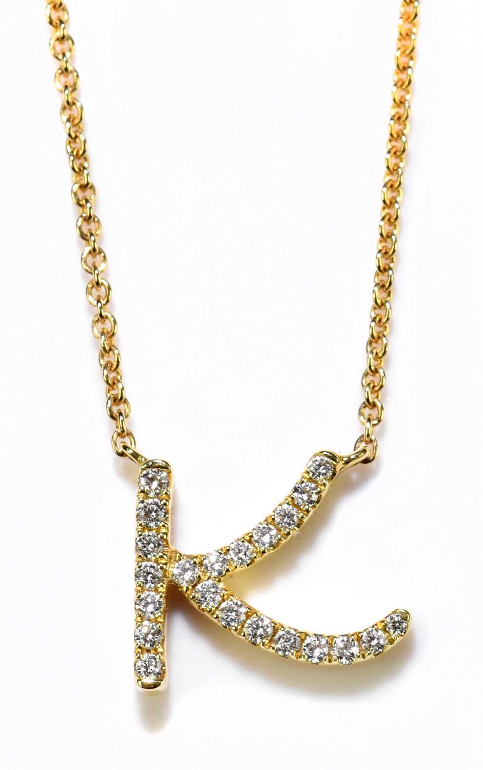 DAVID ROBINSON; an 18ct yellow gold trace chain, suspending a diamond set pendant with the