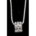An 18ct white gold cobra link chain, set with a brilliant cut diamond set pendant formed of three