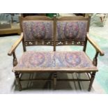 An Arts and Crafts stained beech two seater settee.