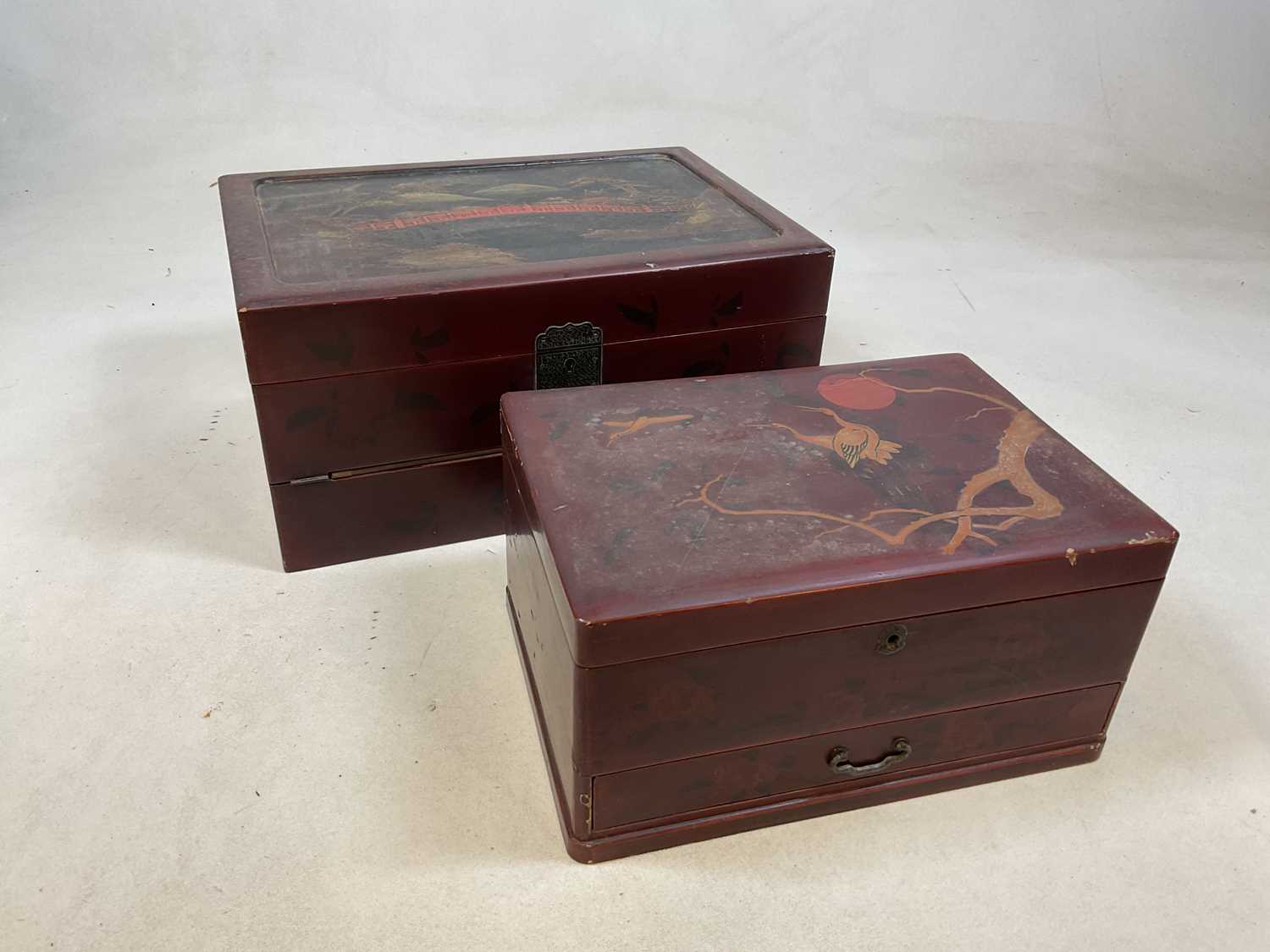 An early 20th century Japanese red lacquered and painted writing slope with hinged interior and