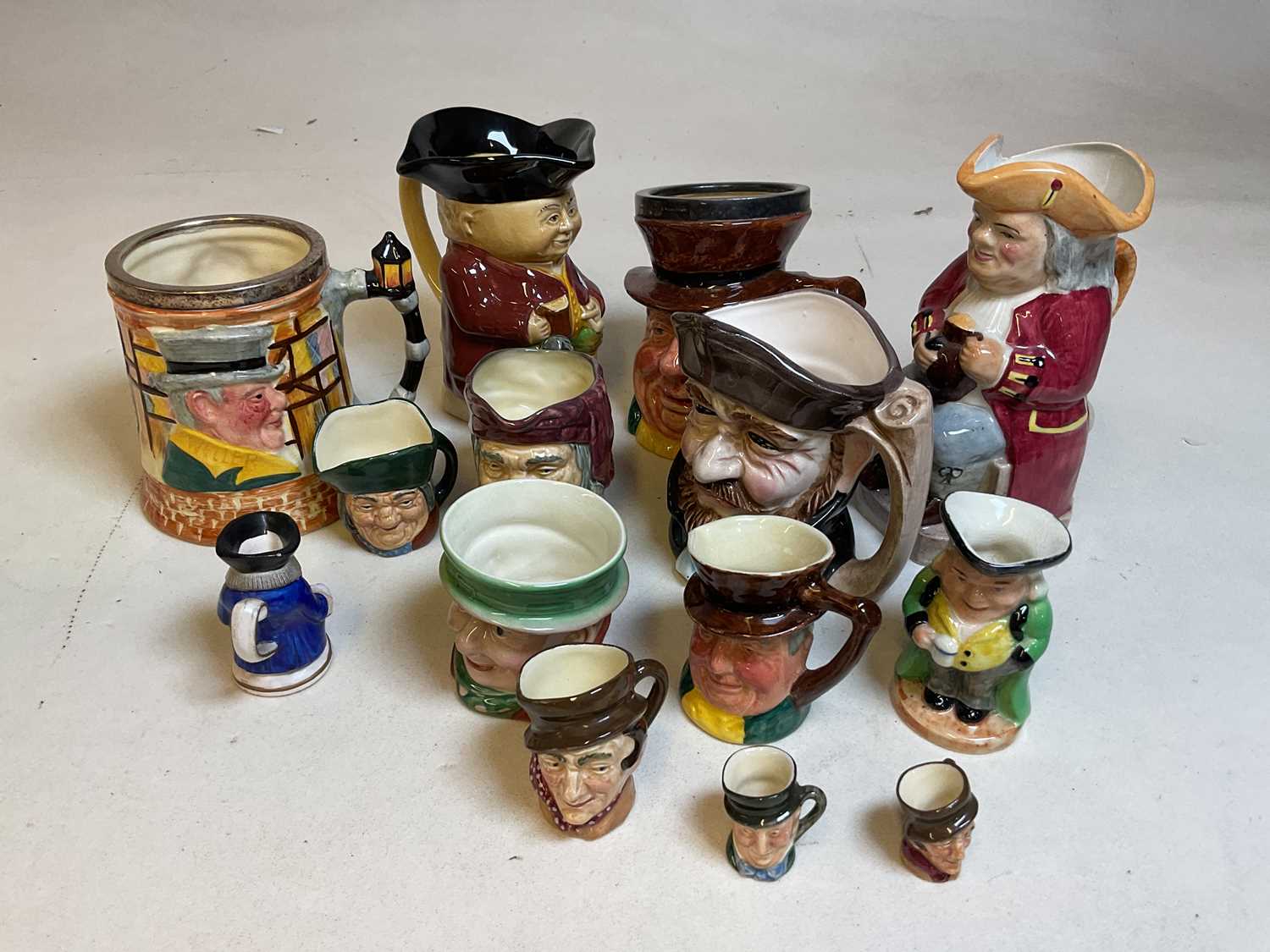 A group of character jugs including Sandland and Royal Doulton.
