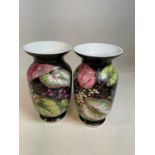 A pair of late Victorian leaf and flower decorated vases on black ground, unmarked, height 34cm.