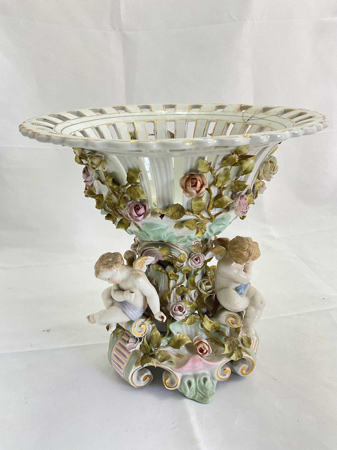 A large late 19th century Continental porcelain centrepiece with pierced circular bowl with