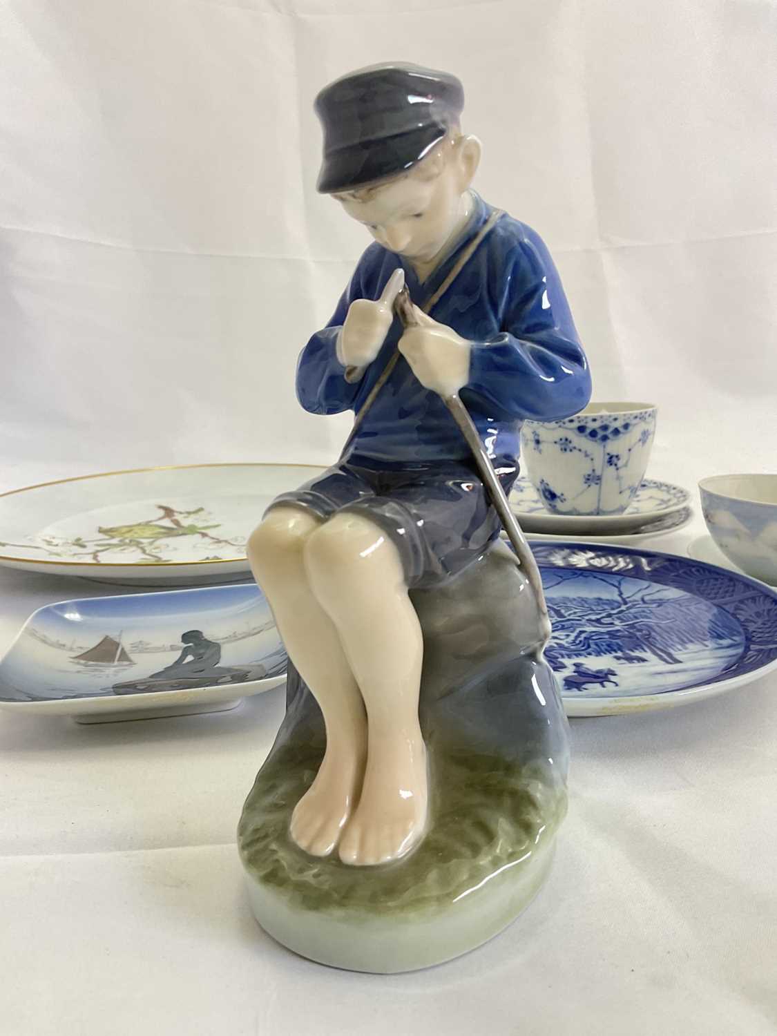 ROYAL COPENHAGEN; a group of wares, including a figure of a young boy whittling his fishing rod, a - Image 4 of 6