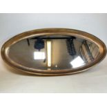 A large contemporary gilt painted oval wall mirror with bevelled plate, width 160cm.