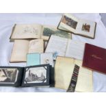 A group of ephemera including sketch books, albums and postcards.