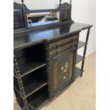 A late Victorian Aesthetic Movement ebonised sideboard with painted door flanked by shelves, width