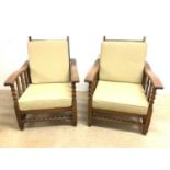 A pair of 1920s oak Morris style reclining armchairs (2)