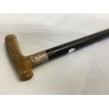 A early 20th century walking stick with horn handle, silver band and ebonised tapering shaft, length