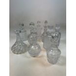 A group of nine cut glass decanters including a pair of hobnail examples, ship's decanter, etc.