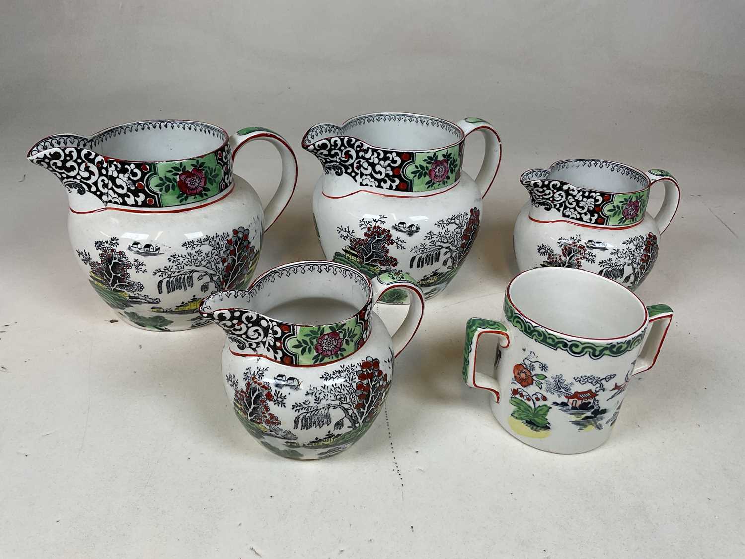 T.G. GREEN & CO LTD; four 'Ming' decorated jugs and a similarly decorated twin handled cup (5).