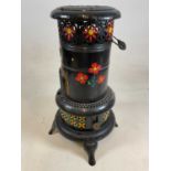 A floral painted portable garden heater.