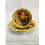 HARRY AYRTON FOR ROYAL WORCESTER; a fruit decorated and gilt heightened cabinet cup and saucer,