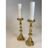 A large and heavy pair of brass pricket candlesticks with turned and knopped stems, height 44cm.