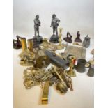 A group of metalware including a brass spit, various half ornaments, candlestick, etc.