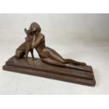 An Art Deco inspired painted plaster figure of a nude young lady with an Alsatian, width 51.5cm.