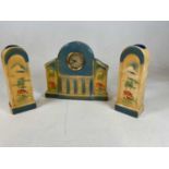 An Art Deco pottery three piece clock garniture with Arabic numerals to the circular dial (3)