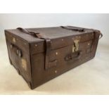 A large rectangular canvas covered trunk with brass clasp and leather straps, 91 x 52cm.