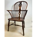 An early to mid-19th century ash and elm hoop back Windsor elbow chair with saddle seat and straight