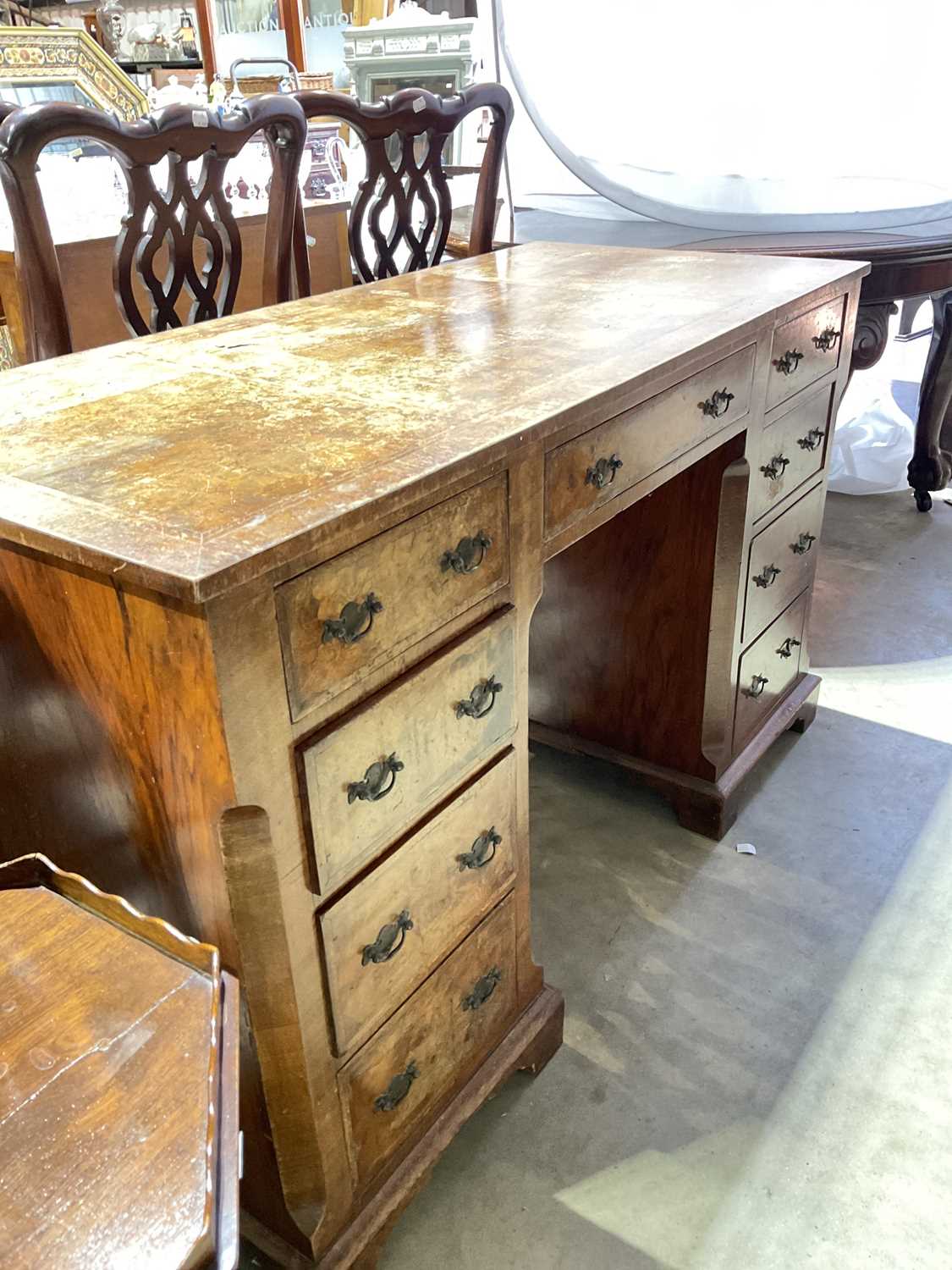 A late 19th/early 20th century burr walnut veneered crossbanded and featherbanded nine drawer