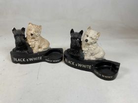 A painted plaster advertising Black & White Scotch Whisky bottle holder, width 31cm, and a near
