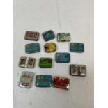 A group of thirteen vintage needle tins (9 full, 4 empty).